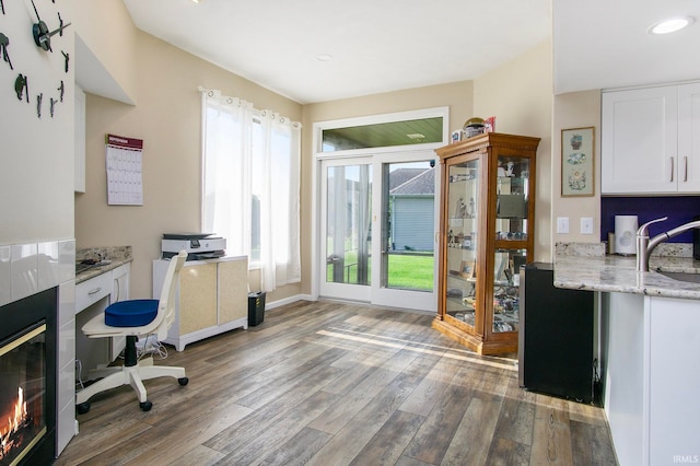 office space with wood-type flooring and sink