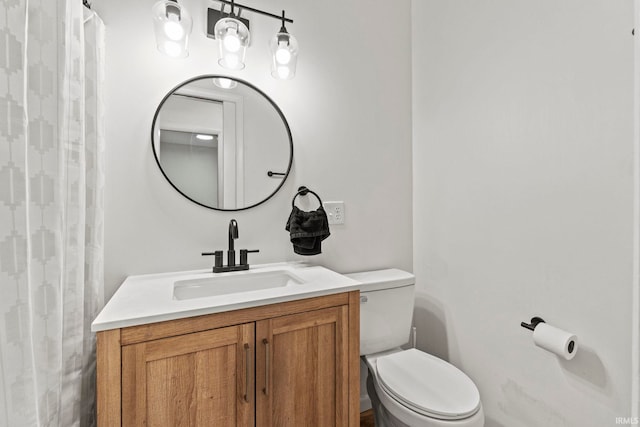 bathroom with a shower with curtain, toilet, and vanity