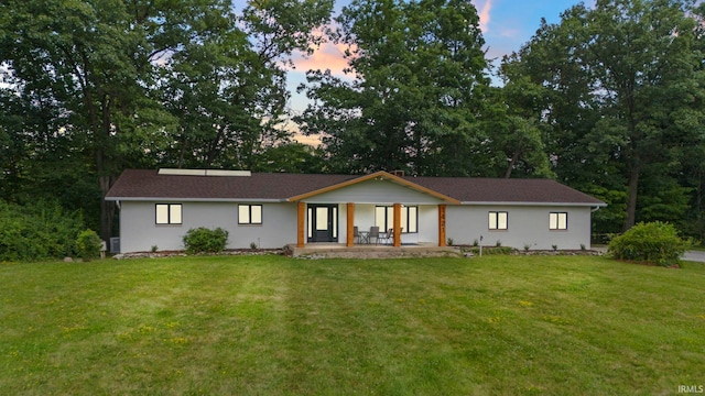 ranch-style house with a yard and a patio