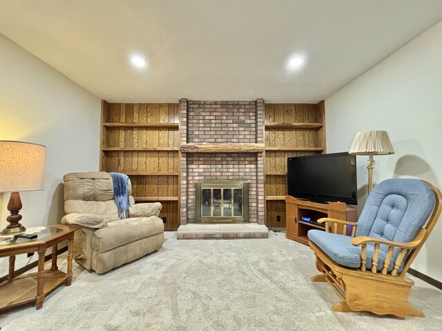 living area featuring carpet floors and a fireplace