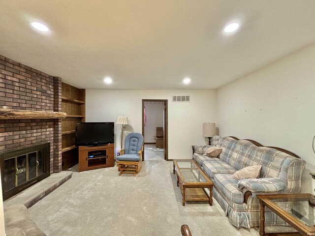 living room with a fireplace and light carpet