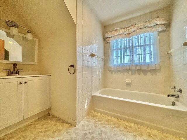 bathroom with vanity and shower with separate bathtub