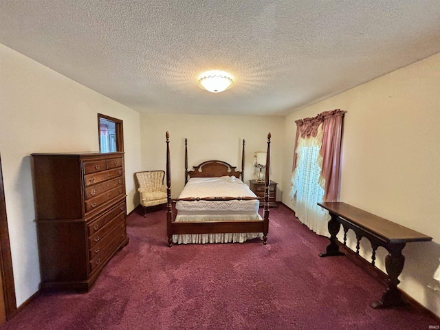 bedroom with a textured ceiling and dark colored carpet