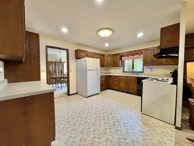 kitchen with white appliances, sink, and range hood