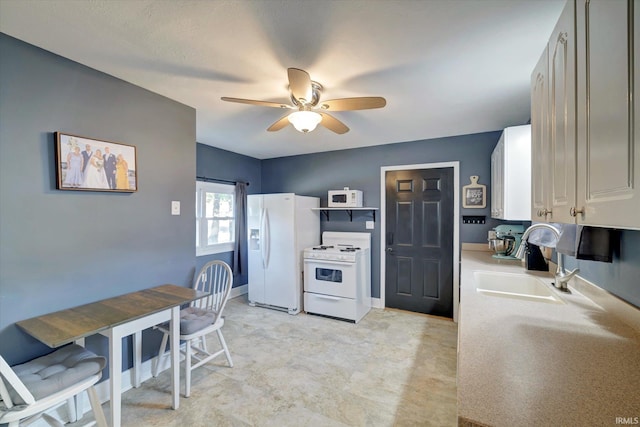 kitchen with white appliances, sink, and ceiling fan