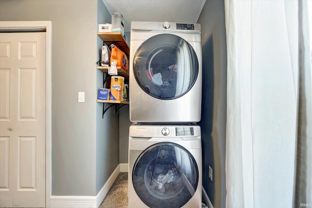 laundry area with stacked washing maching and dryer