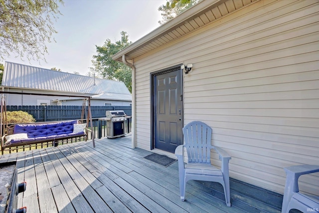 wooden terrace featuring grilling area and an outdoor hangout area