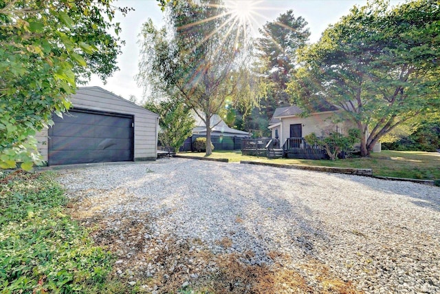 exterior space with a garage and an outbuilding