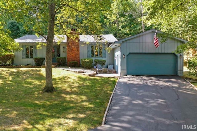 ranch-style home featuring a garage and a front lawn