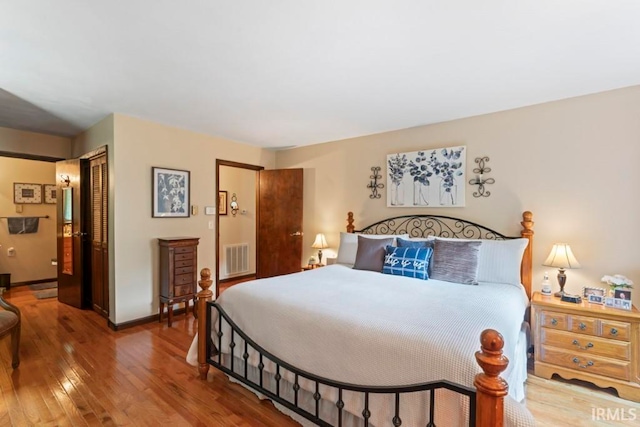 bedroom with hardwood / wood-style flooring and a closet