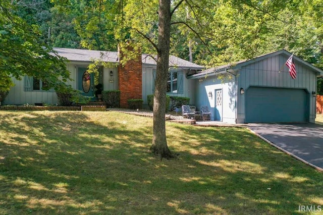 ranch-style house with a garage and a front yard