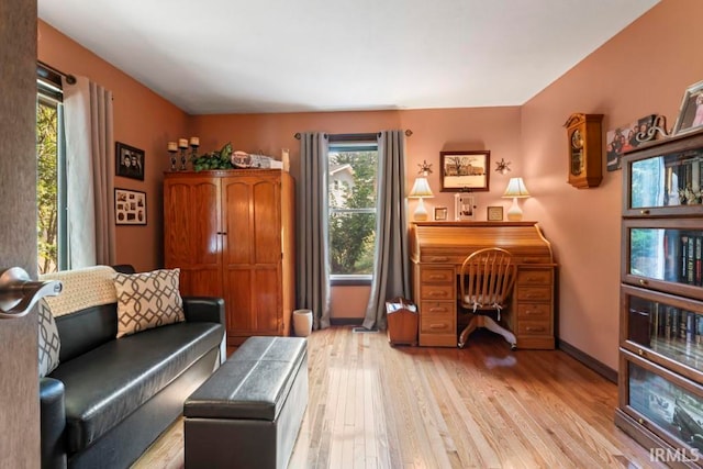 home office with light hardwood / wood-style flooring