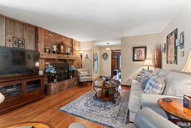 living room with hardwood / wood-style floors and a fireplace