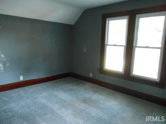 bonus room featuring lofted ceiling and carpet flooring