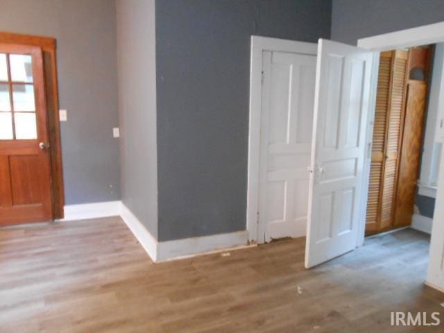 unfurnished bedroom featuring light wood-type flooring and a closet