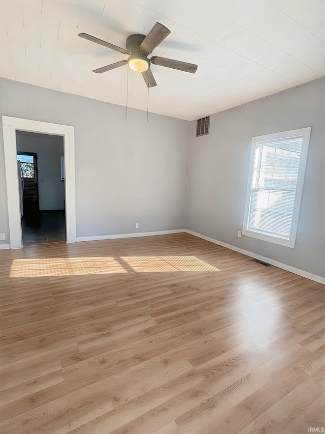 spare room with ceiling fan and light hardwood / wood-style floors