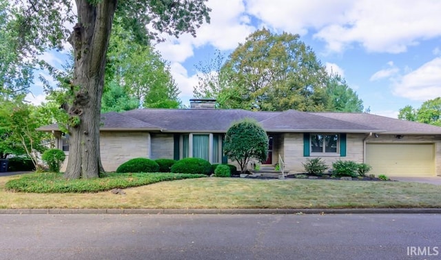 ranch-style house with a garage and a front lawn