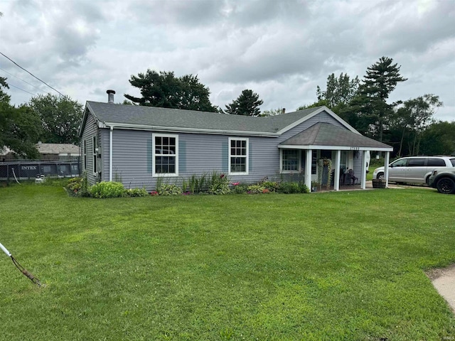 rear view of house featuring a yard