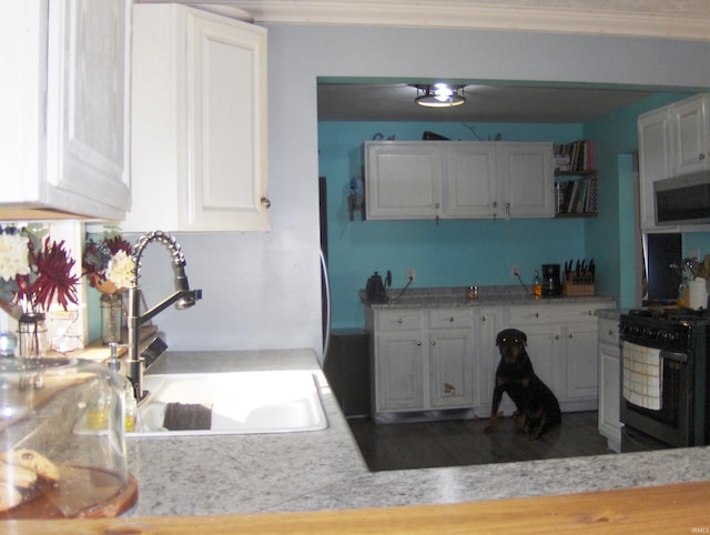 kitchen featuring crown molding, white cabinetry, sink, dark hardwood / wood-style floors, and black electric range