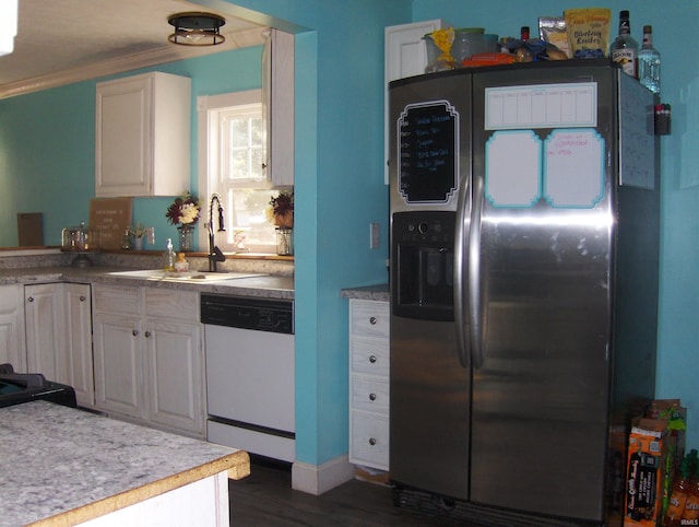 kitchen featuring stainless steel refrigerator with ice dispenser, white cabinets, sink, and dishwasher