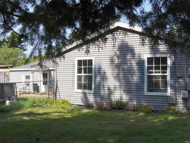 view of property exterior featuring a lawn