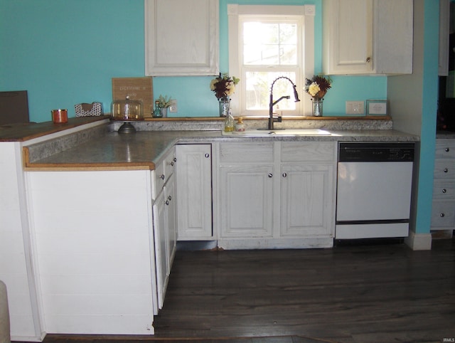 kitchen featuring white dishwasher, sink, dark hardwood / wood-style flooring, and white cabinets