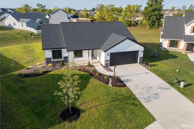 modern farmhouse featuring roof with shingles, a garage, a residential view, stone siding, and driveway