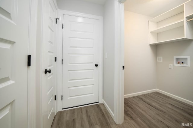 laundry room featuring hookup for a washing machine, laundry area, baseboards, and wood finished floors