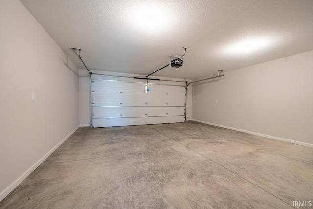 garage with baseboards and a garage door opener