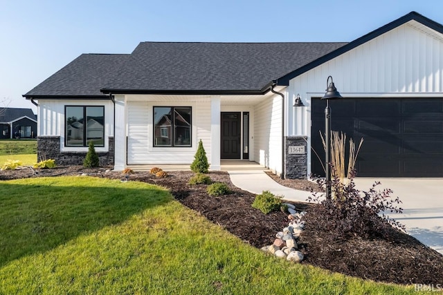 view of front of house with a front yard and a garage