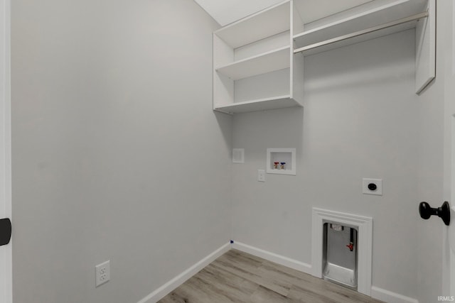 washroom featuring hookup for a washing machine, light wood-style flooring, hookup for an electric dryer, laundry area, and baseboards