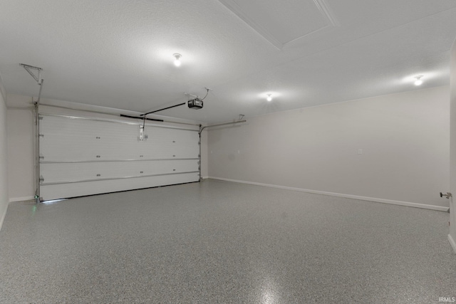 garage featuring a garage door opener and baseboards