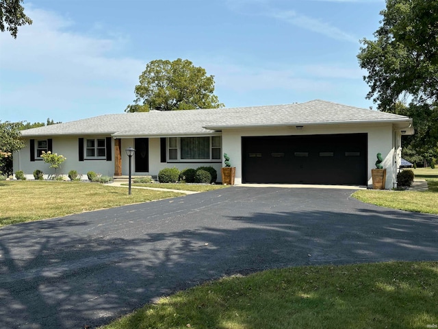 ranch-style home with a garage and a front yard