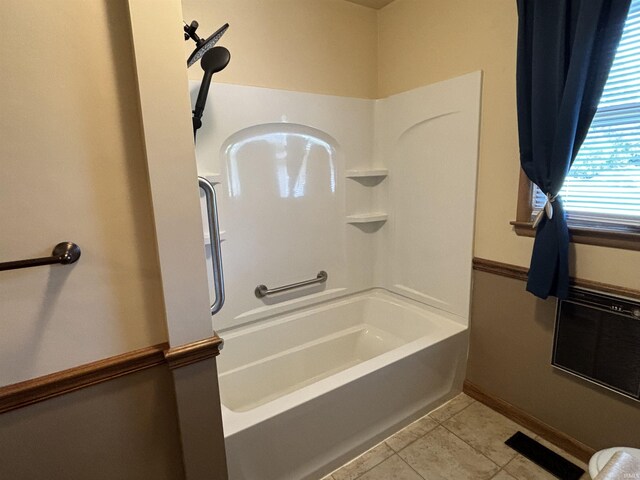 bathroom featuring washtub / shower combination and tile patterned floors