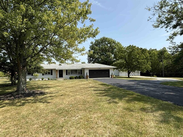 ranch-style house with a garage and a front yard