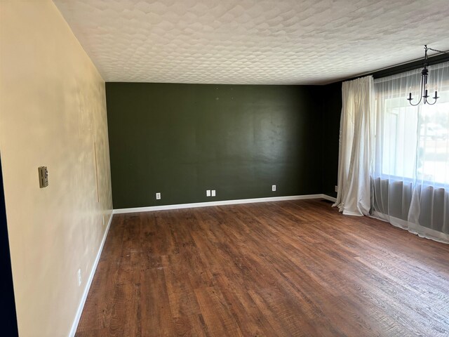 empty room with dark hardwood / wood-style flooring