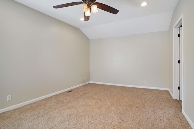 carpeted empty room featuring lofted ceiling and ceiling fan