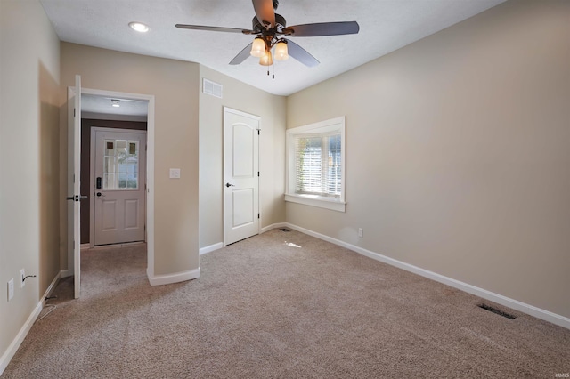 unfurnished bedroom featuring light colored carpet and ceiling fan