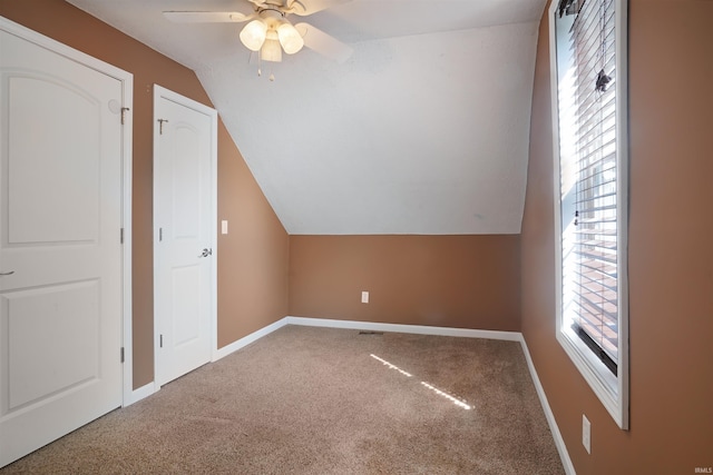 bonus room with ceiling fan, carpet floors, and vaulted ceiling