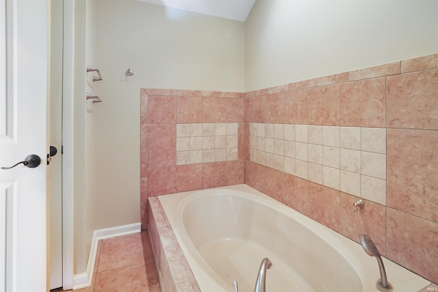 bathroom featuring tiled bath and tile patterned floors