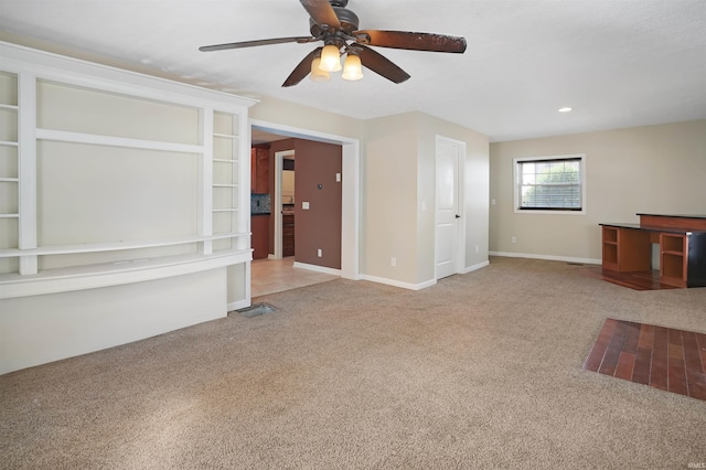 unfurnished living room featuring ceiling fan and carpet floors