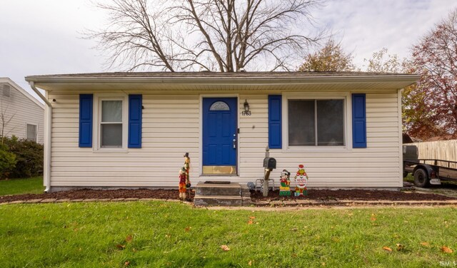 bungalow-style house featuring a front yard