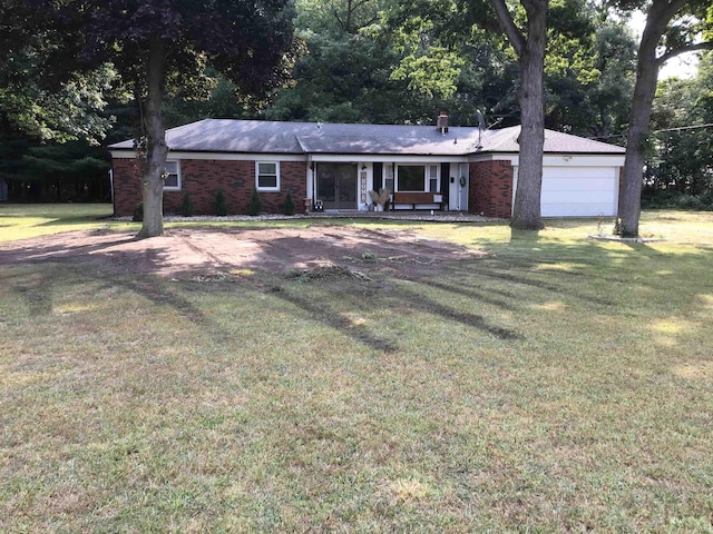 ranch-style house featuring a garage and a front lawn