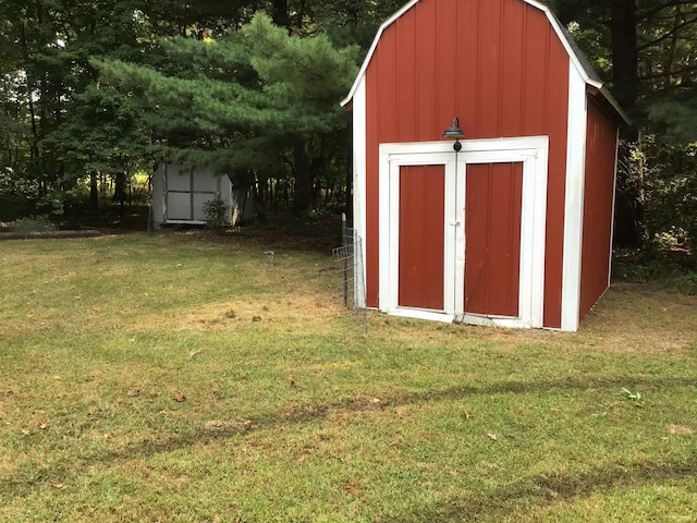 view of outbuilding with a yard