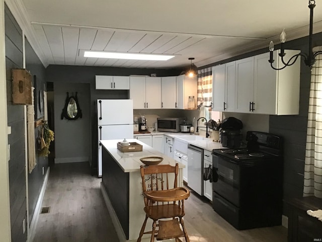 kitchen featuring white cabinets, hardwood / wood-style floors, stainless steel appliances, and sink