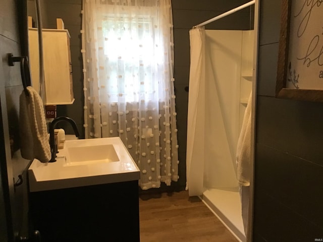 bathroom featuring vanity, wood-type flooring, and curtained shower