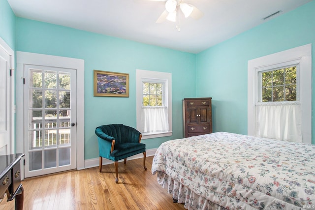 bedroom featuring multiple windows, ceiling fan, and light hardwood / wood-style floors