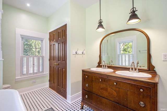 bathroom with tile patterned flooring, vanity, and toilet