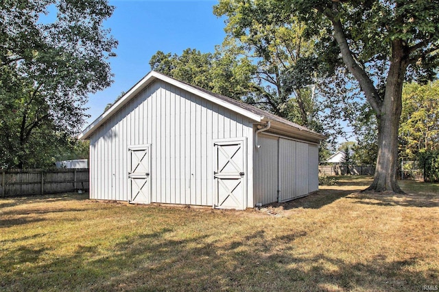 view of outbuilding featuring a lawn