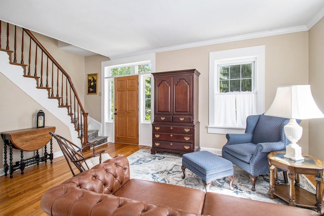 living room featuring light hardwood / wood-style flooring and ornamental molding